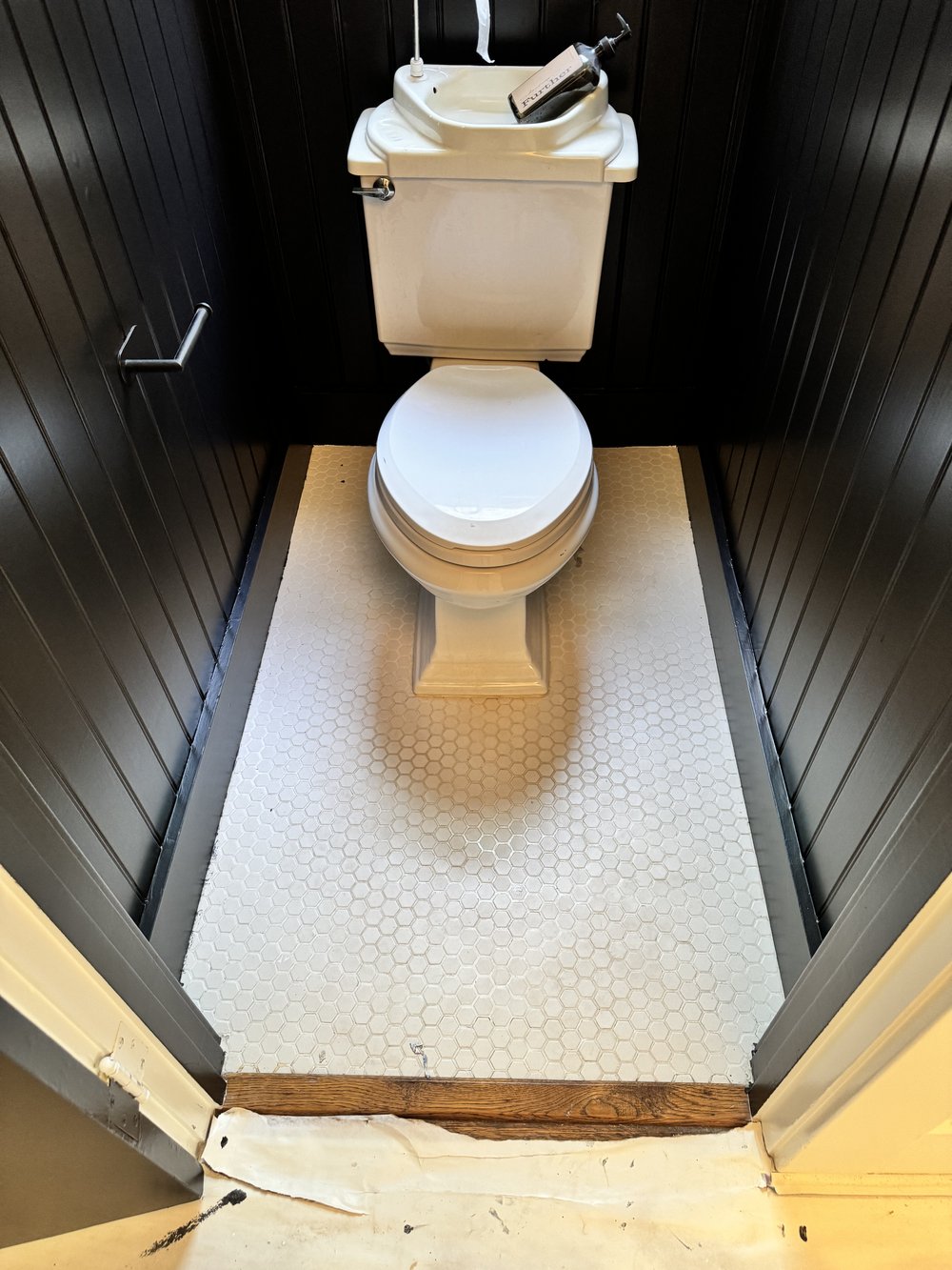 Bathroom refinishing &mdash; Completed half-bath with reglazed floor tile and updated fixtures &mdash; Belmont, CA