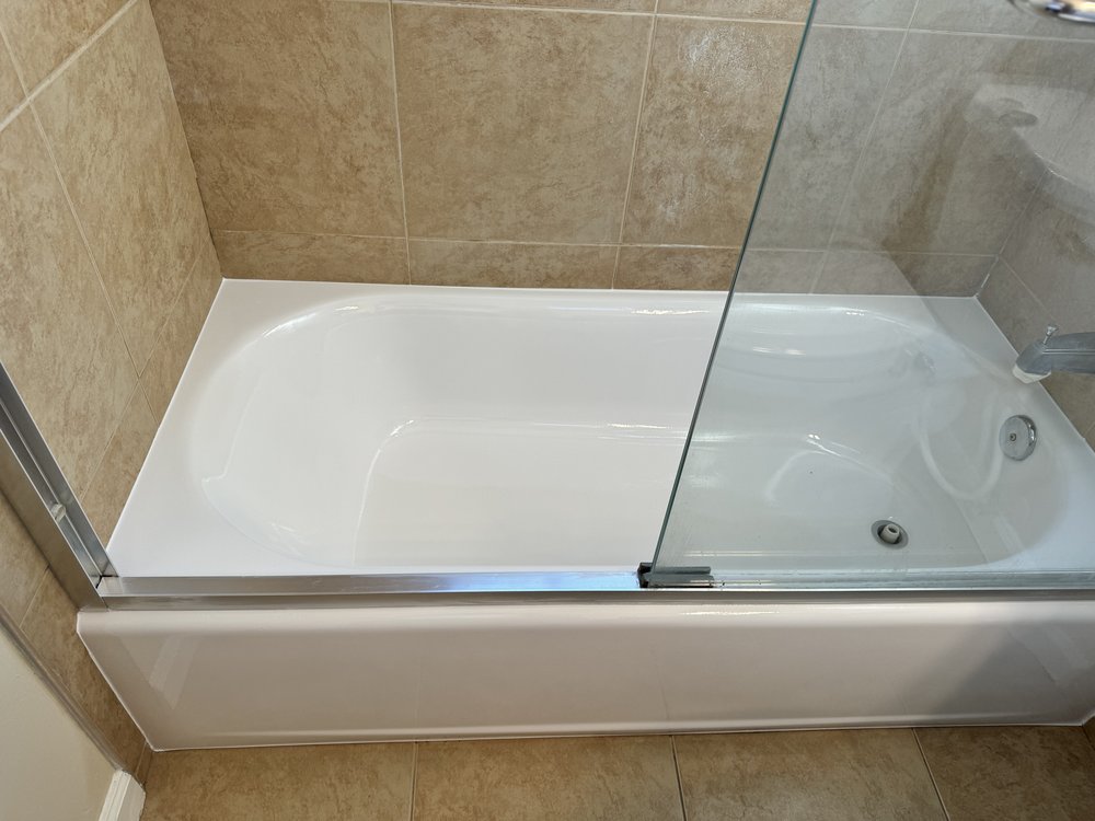 Alcove bathtub after reglazing in Sunnyvale, CA &mdash; bright white finish with beige tile walls and glass shower door