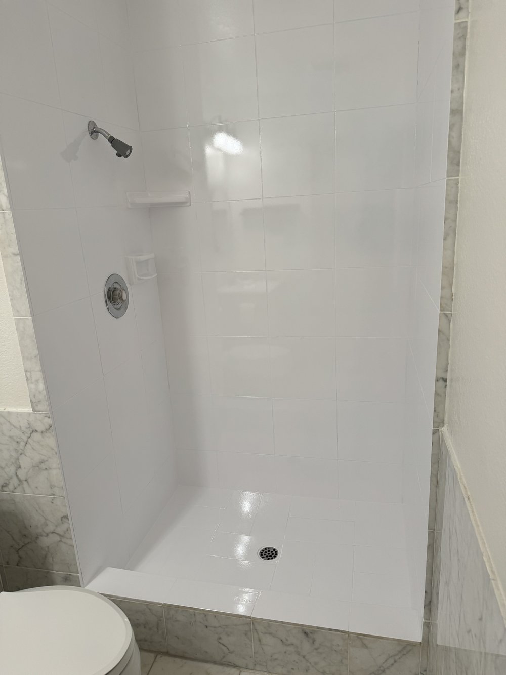 After refinishing in Palo Alto, CA &mdash; same corner shower with glossy white tile walls, pan, and chrome fixtures