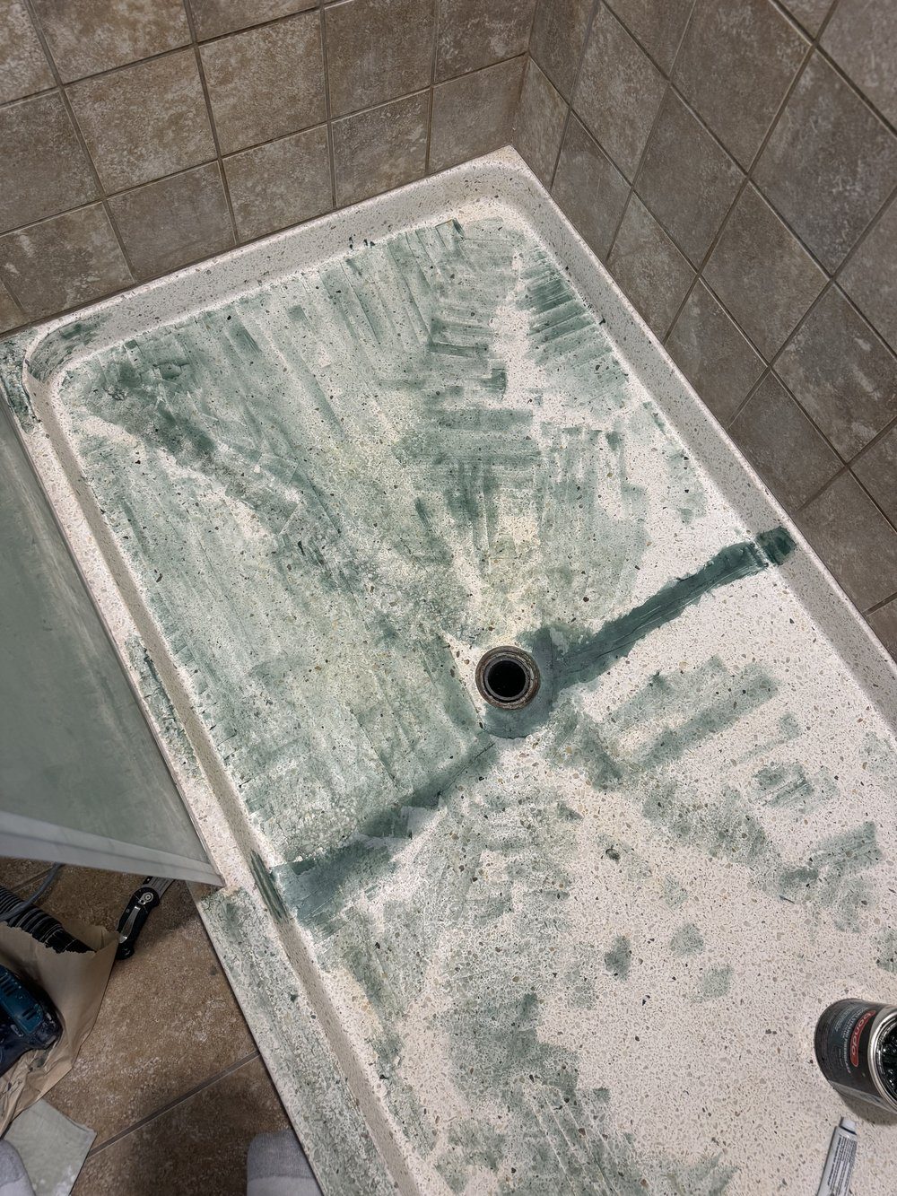 Before reglazing in Fremont, CA &mdash; shower pan with deep green stains treated around the central drain