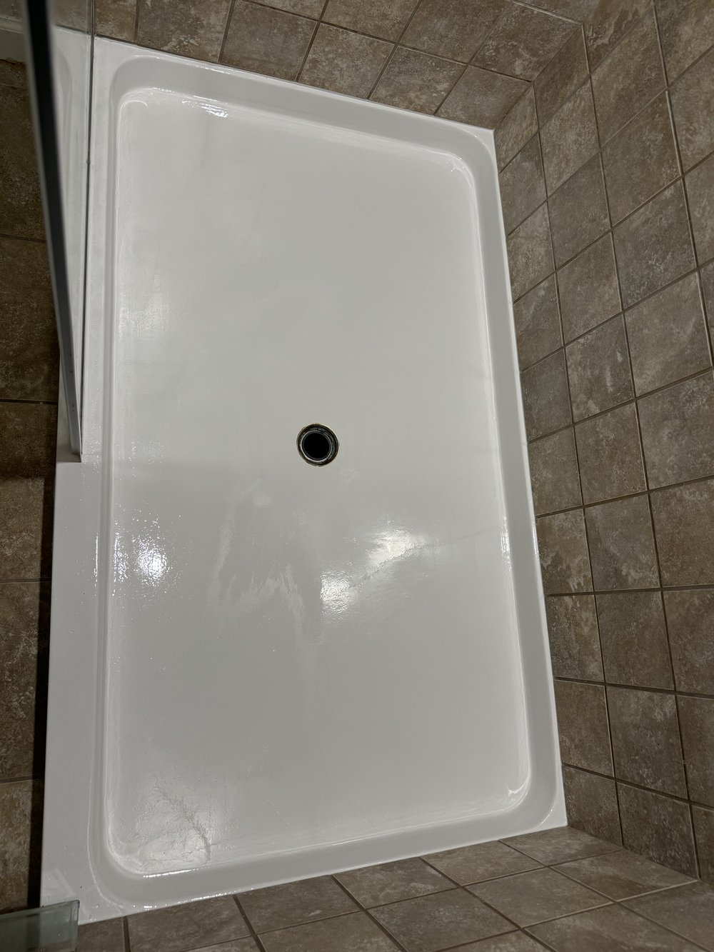 After reglazing in Fremont, CA &mdash; shower pan restored to bright white over beige stone-look wall tile