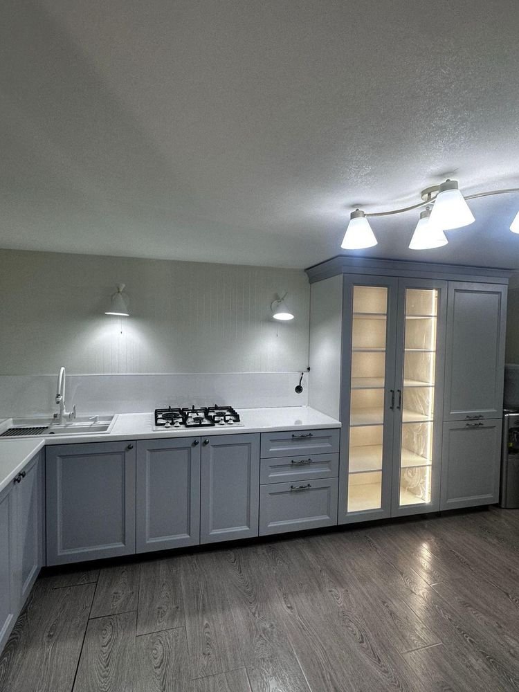 Kitchen cabinet refinishing &mdash; Finished kitchen with backlit glass cabinets and quartz counters &mdash; Redwood City, CA