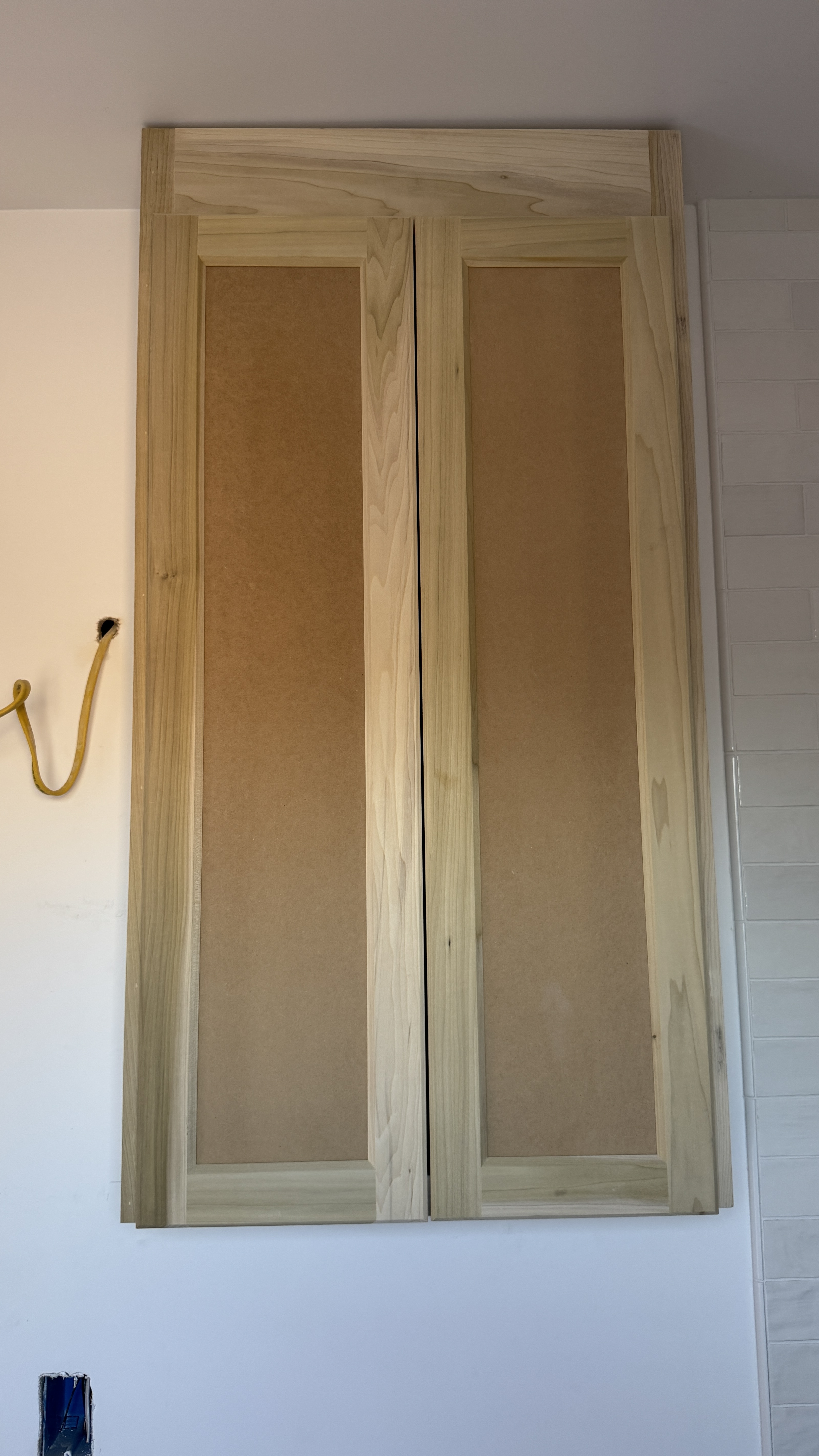 Kitchen cabinet installation &mdash; Unfinished doors and frames on site before final coating &mdash; Saratoga, CA