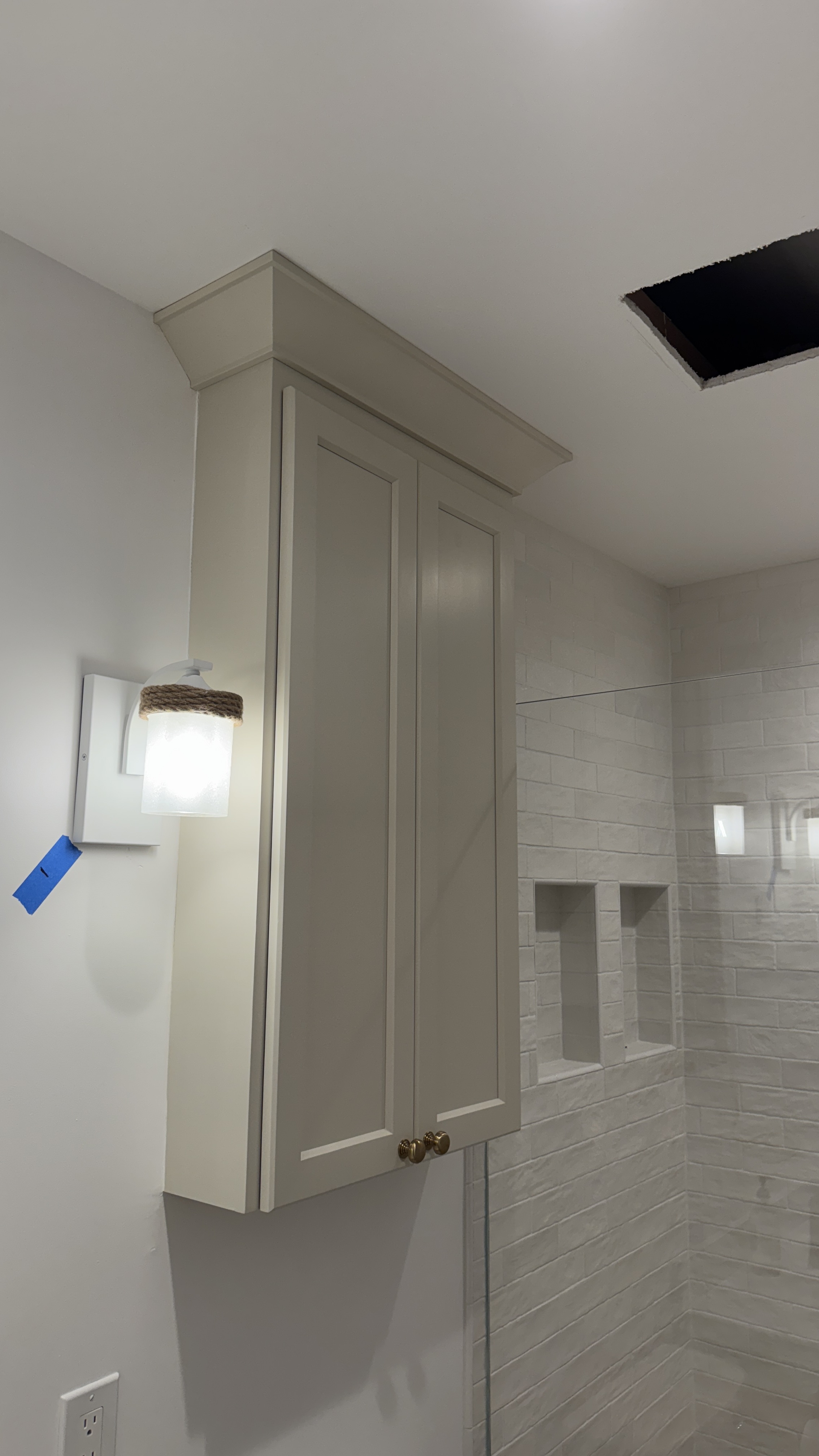 Bathroom cabinet refinishing &mdash; Completed wall cabinet refinish beside the tiled shower &mdash; Saratoga, CA