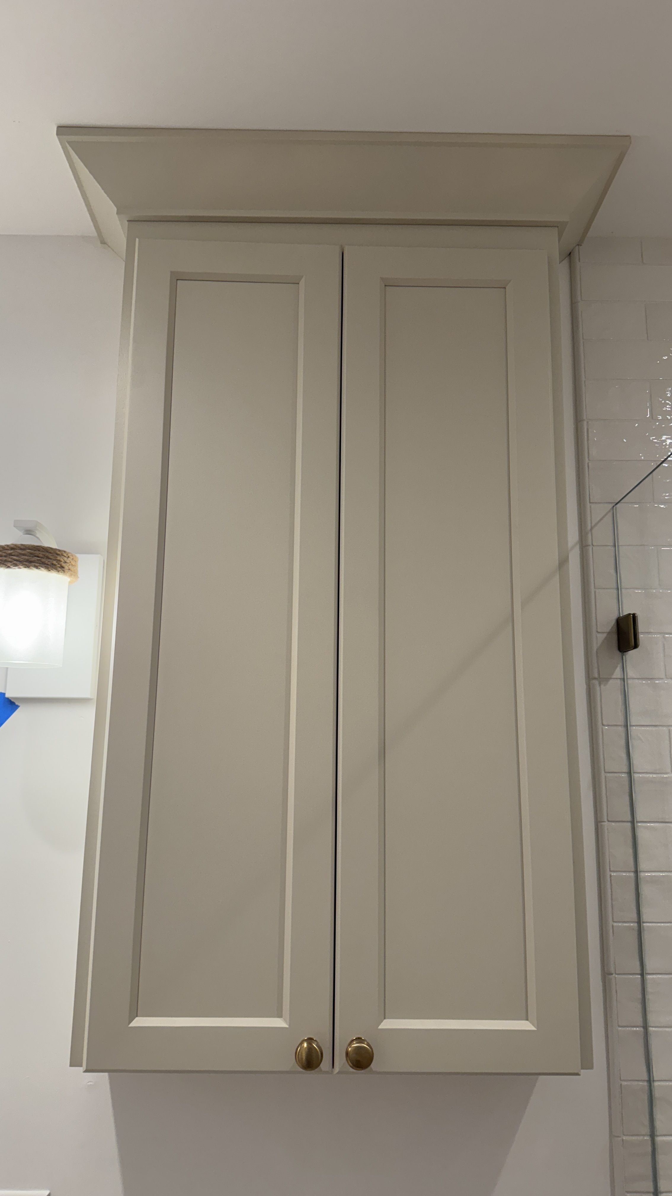 Bathroom cabinet refinishing &mdash; Finished wall cabinet with hardware beside shower tile &mdash; Saratoga, CA