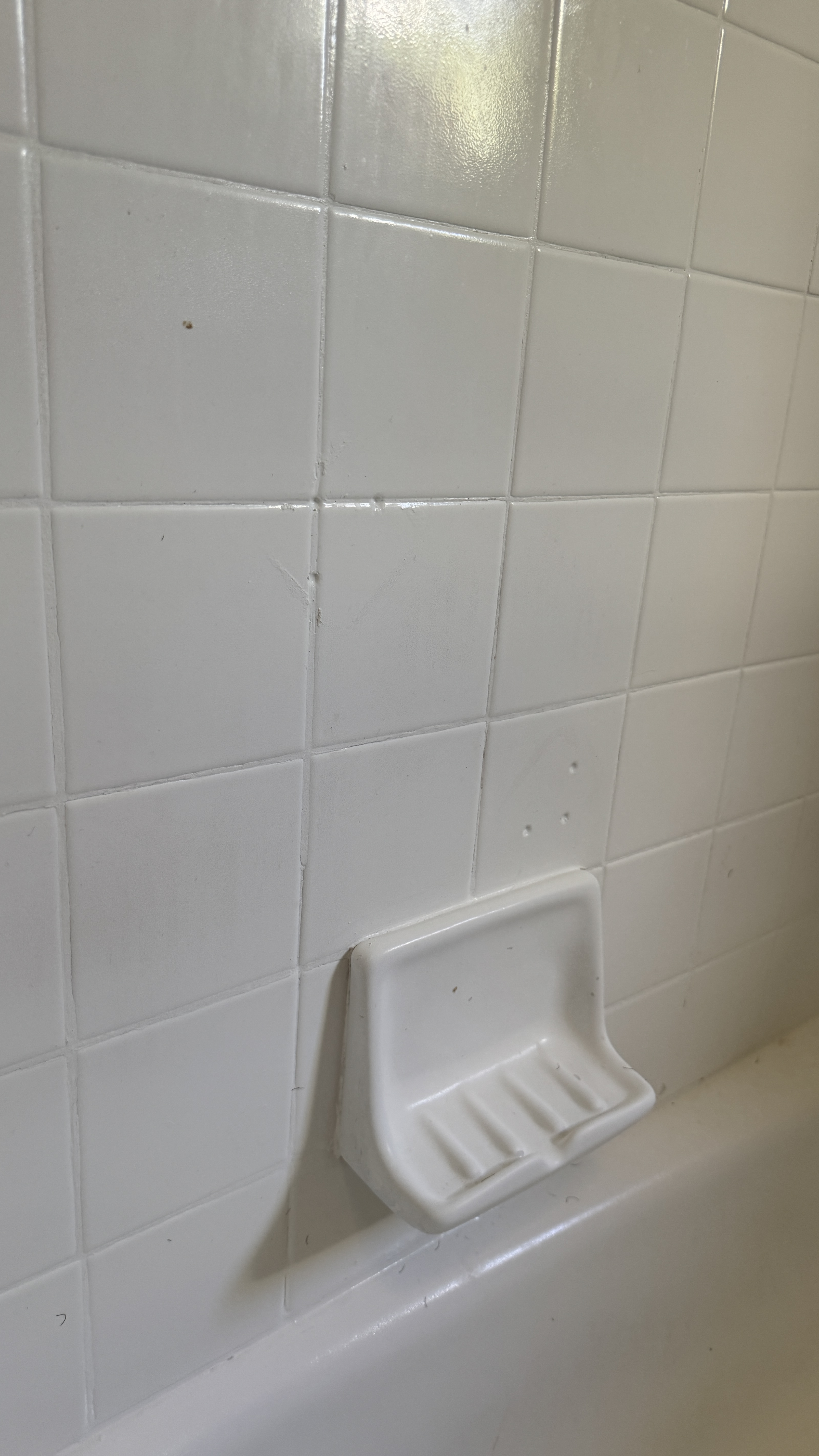 Bathtub reglazing &mdash; Tile surround masked to protect grout lines during spray work &mdash; Oakland, CA