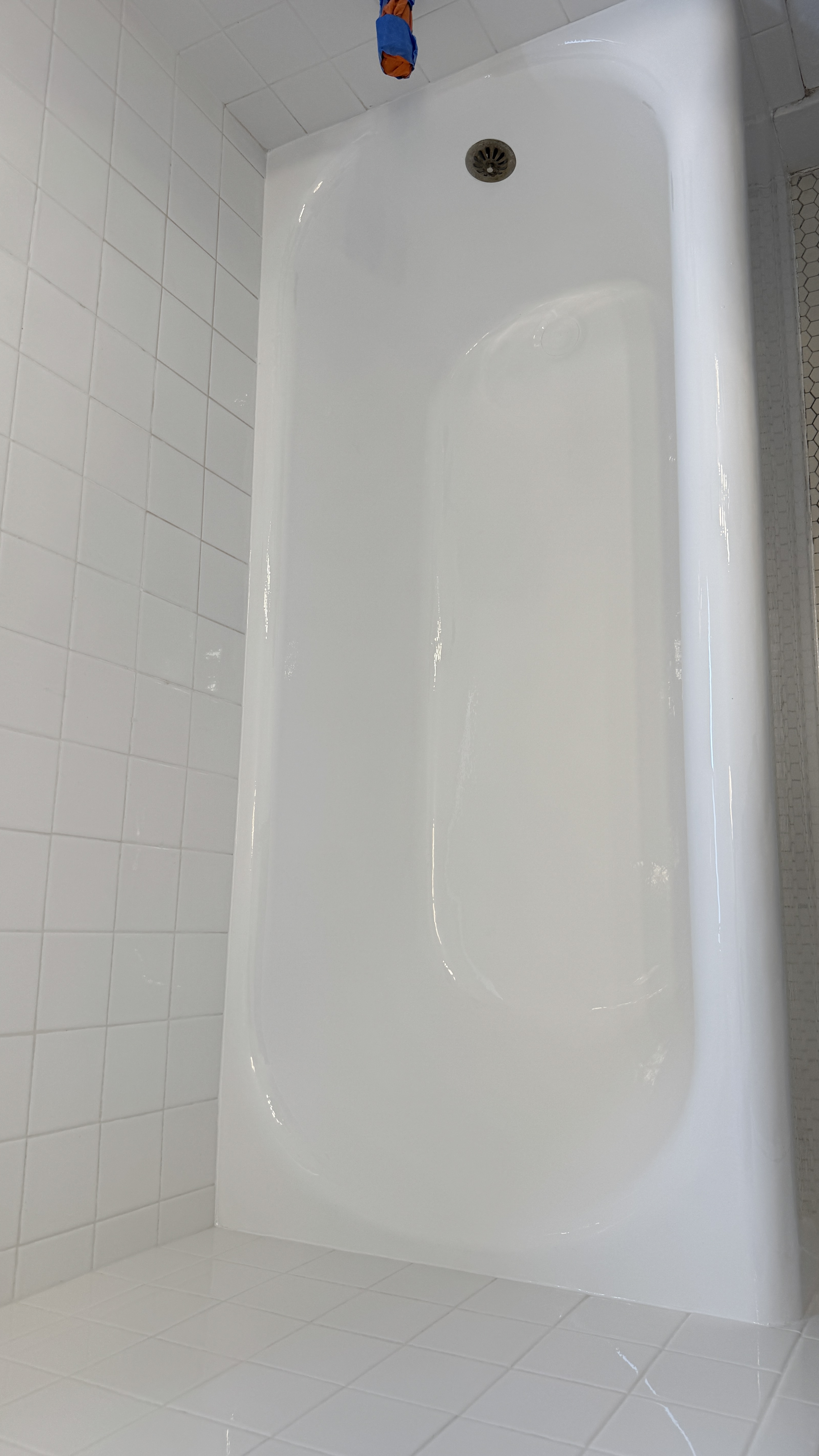 After reglazing in Oakland, CA &mdash; alcove tub restored with a bright white high-gloss finish