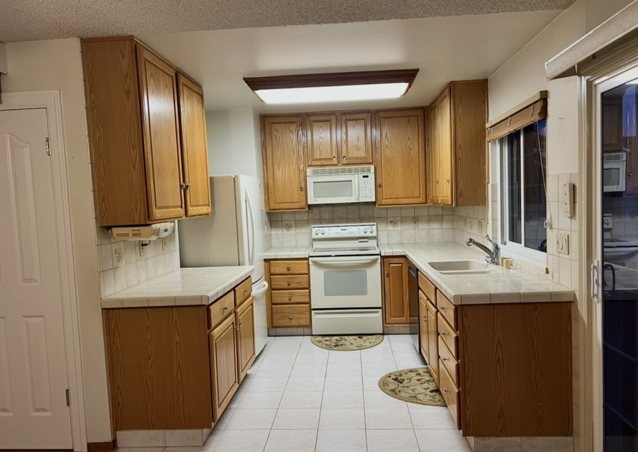 Before remodel in Walnut Creek, CA &mdash; dated golden-oak kitchen cabinets with tile counters