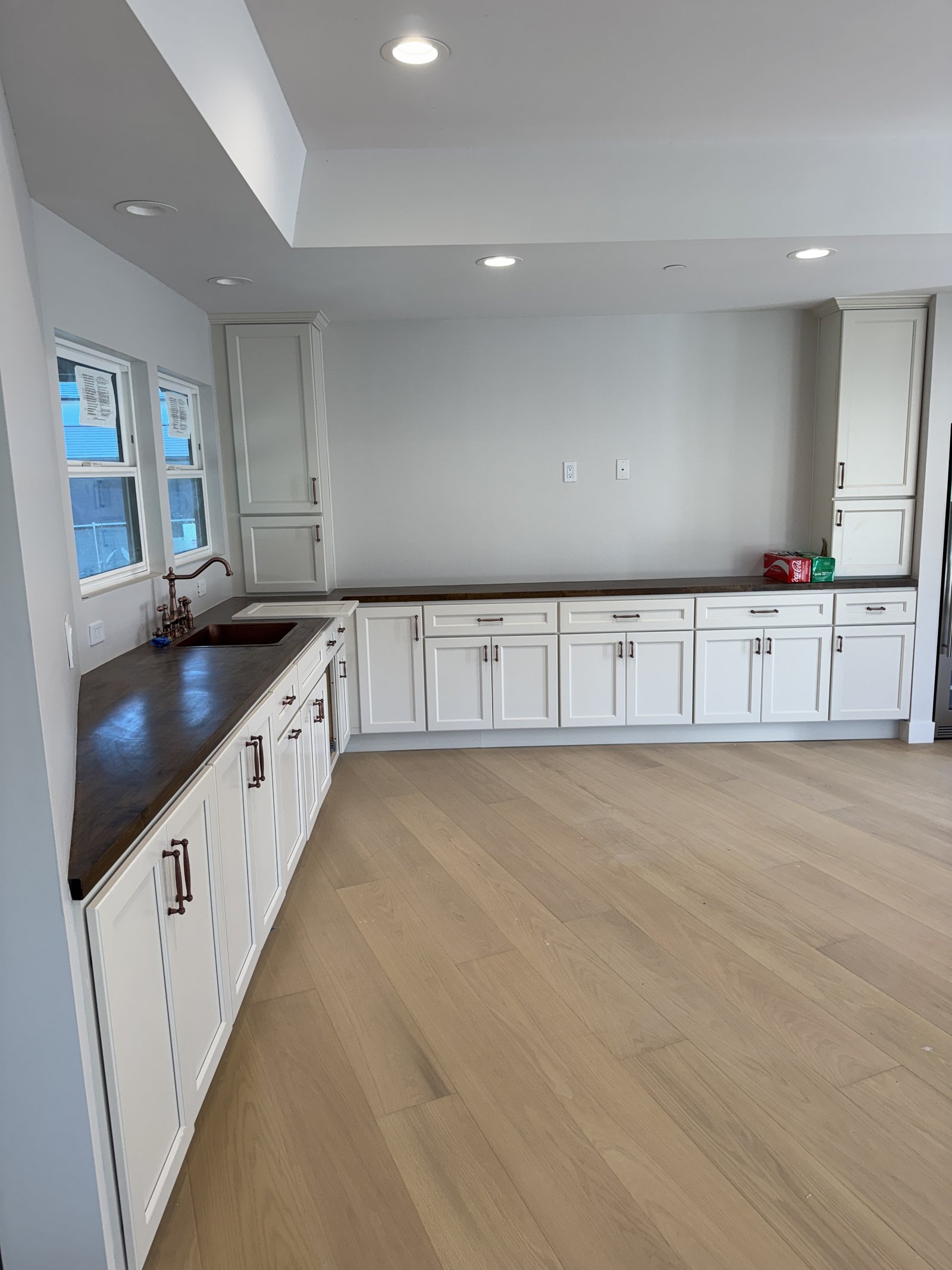 Kitchen cabinet installation &mdash; Completed kitchen with white cabinetry and dark countertops &mdash; Santa Clara, CA